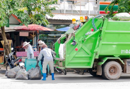 High-visibility trained staff handling commercial waste containers